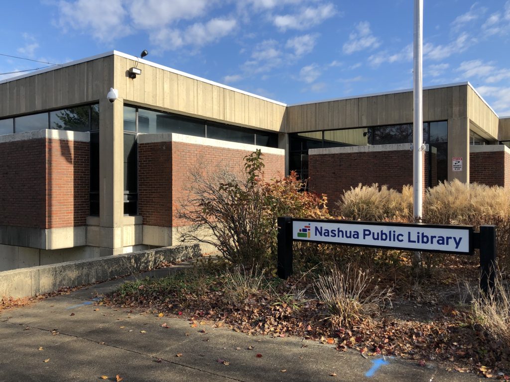 Nashua Public Library with sign in the fall.