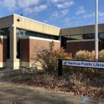 Nashua Public Library with sign in the fall.